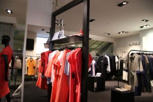 Clothing store display with garments on hangers